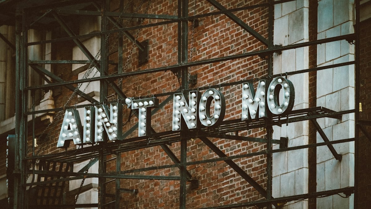 a brick wall with a sign on it
